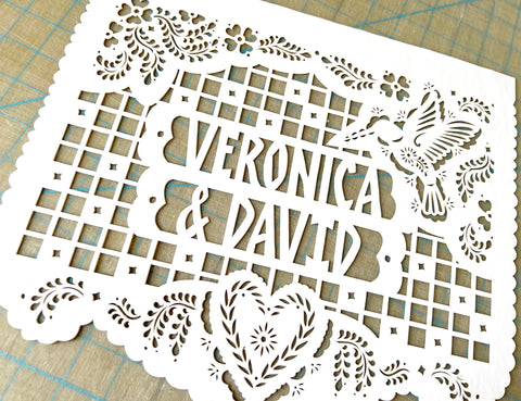 Personalized papel picado design with a hummingbird, flowers, and a heart. Design original to Ay Mujer Shop